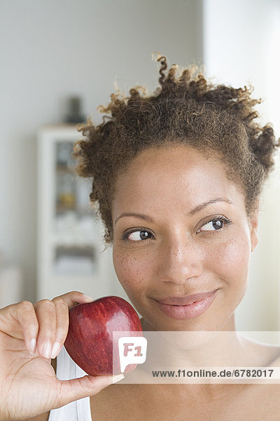 Portrait of attractive woman holding apple