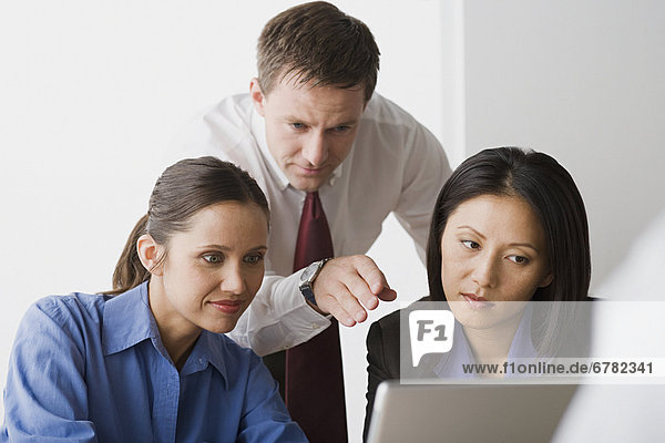 Three people working in office