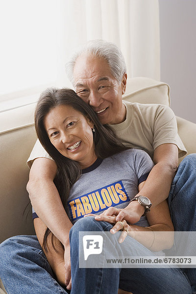 Portrait of couple relaxing on sofa