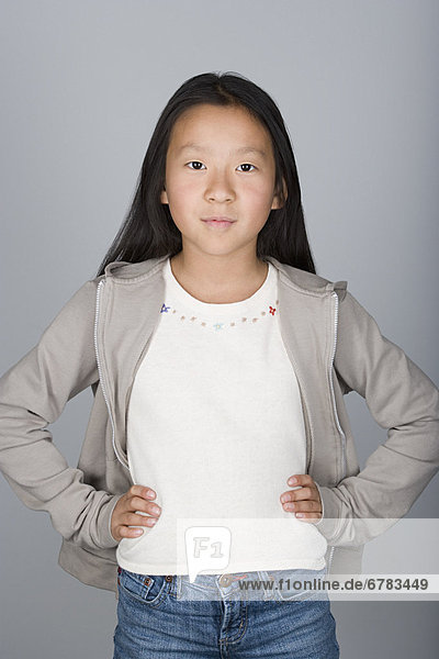 Studio portrait of confident Chinese teenage girl (16-17)