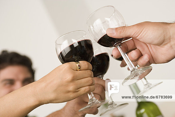 Hands holding wineglasses during toast