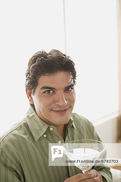 Portrait of smiling man having cocktail