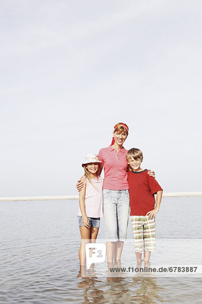 Family posing on beach