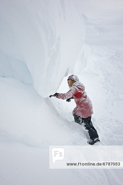 Girl climbing in snow  Haines Summit  British Columbia