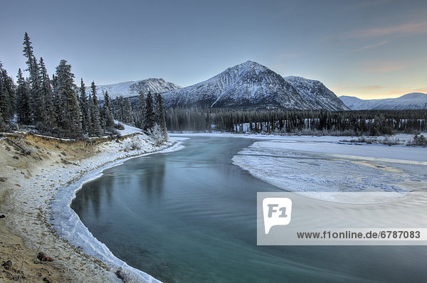 Clear  clean waters of Takhini River in late fall with Mount Vanier in background  Kusawa Lake Territorial Park  Yukon Territory  Canada