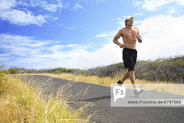 Hawaii  Oahu  Makapu'u  Athletic male running along the makapuu hiking trail