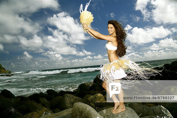 Hawaii  Kauai  Kealia  Beautiful Hawaiian girl dancing hula on ocean shoreline.