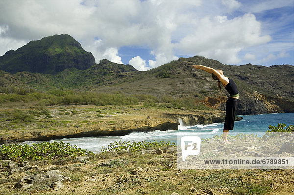 Hawaii  Kauai  Mahaulepu  Woman doing yoga.