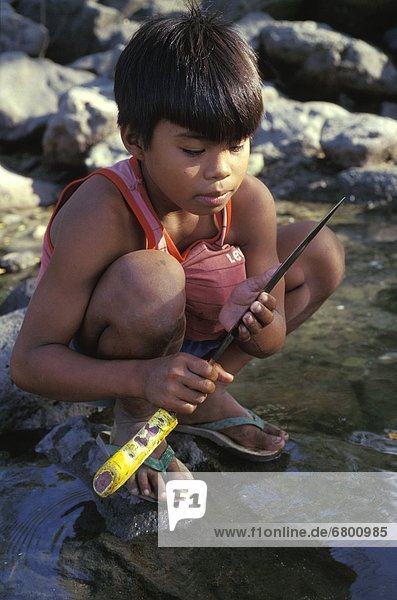 Young Boy Fishing With Spear