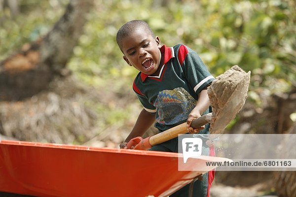 Boy Shoveling Dirt Into Wheelbarrow  Tasbapauni  Nicaragua