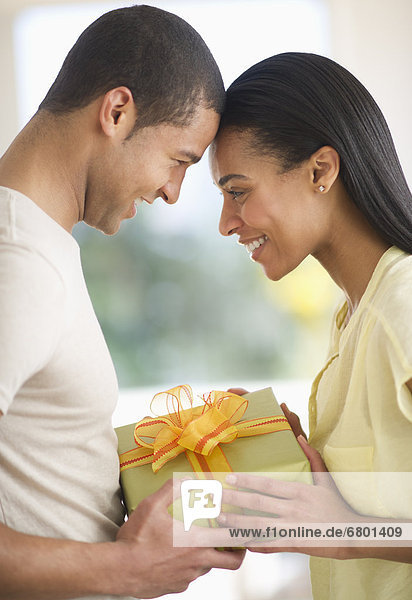 Couple holding gift box