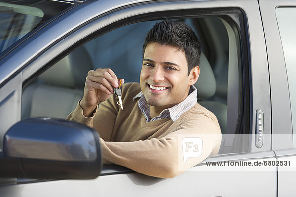 Man sitting in his new car