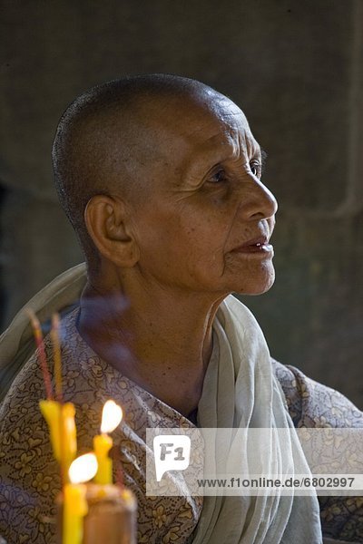 Nun In Prayer At Angkor Wat Temple  Siem Reap Cambodia