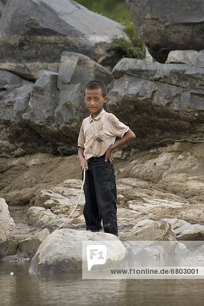 Child Standing On The Banks Of The Mekong River  Luang Prabang Laos