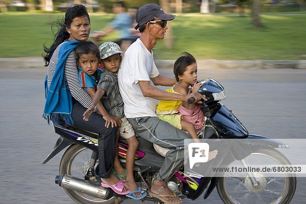 Family Riding On A Scooter Together Without Safety Helmets  Siem Reap Cambodia