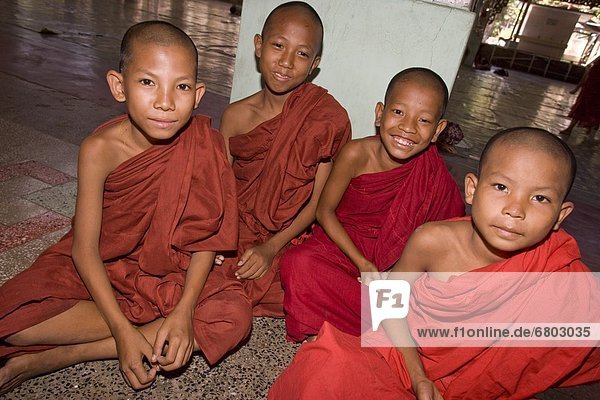 Yangoon Myanmar Four Young Buddhist Monks In A Temple