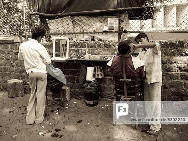 Outdoors Barber Serving A Customer  Mumbai India
