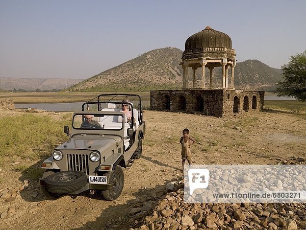 Tourist Sitting In Off Road Vehicle In A Rural Scenic Spot  Aravalli Hills Rajasthan India