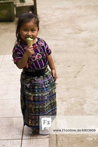 Central America Little Girl In Traditional Dress Eating Ice-Cream  Patzicia Guatemala