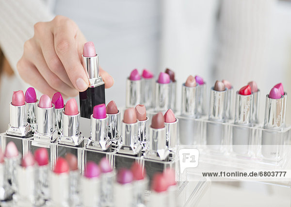 Hand of woman choosing lipstick