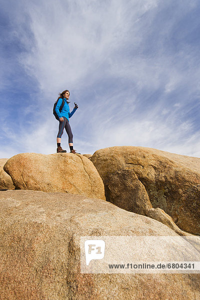 USA  California  Joshua Tree National Park  Female hiker on rocks