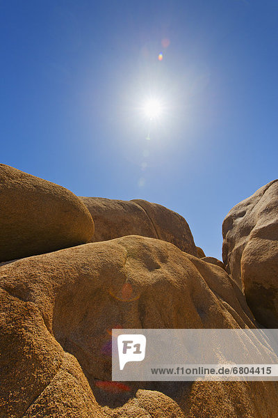 USA  California  Joshua Tree National Park  Desert rocks with solar flare