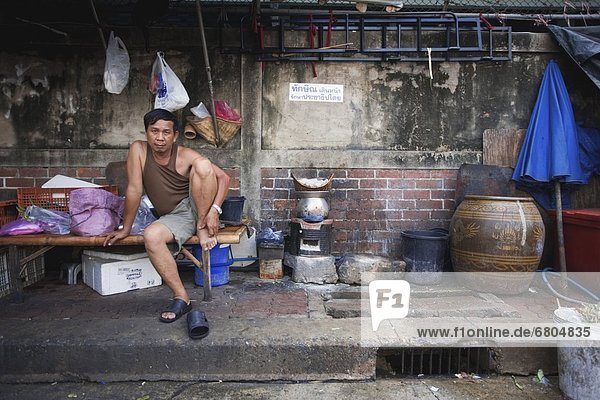 Man Sitting In Impoverished Setting
