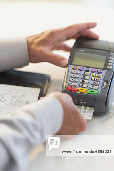 Man inserting credit card in credit card machine