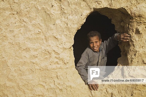 A Smiling Berber Boy Looking Out From The Fortress Of Shali In Siwa  Egypt