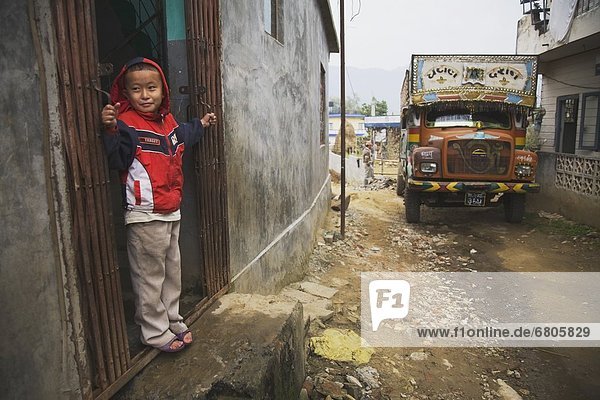 A Boy Standing In A Doorway  Pokhara  Nepal