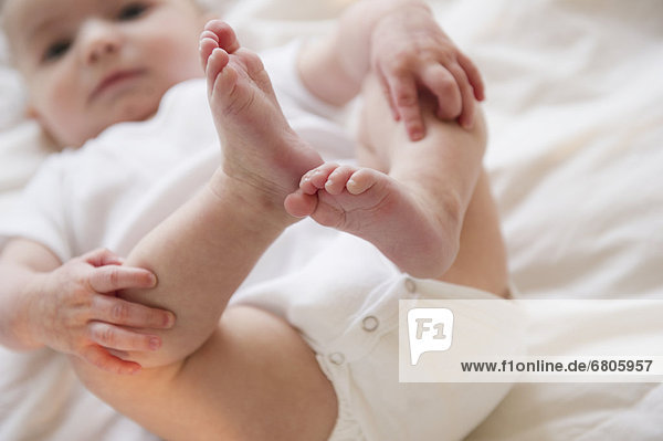 Baby boy (2-5) touching legs