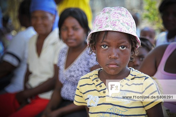A Girl With A Sad Face And Women Sitting Behind Her In The Hope Alive Clinic  Grand Saline  Haiti