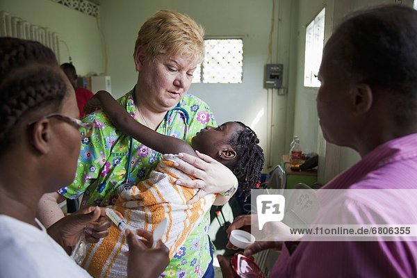 A Volunteer Nurse Cares For A Child That Suffers From Seizures  Grand Saline  Haiti