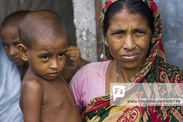 A Woman Holding A Young Boy  Sylhet  Bangladesh
