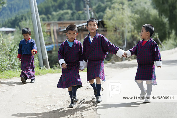 Bhutanese Schoolchildren Walking On Road  Chokhor Valley Bhutan