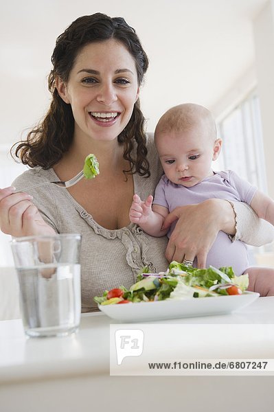 Mother and baby boy (2-5 months) eating salad
