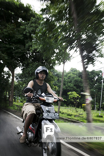 Man on scooter  bali indonesia