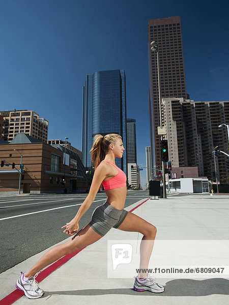 USA  California  Los Angeles  Young woman exercising on city street