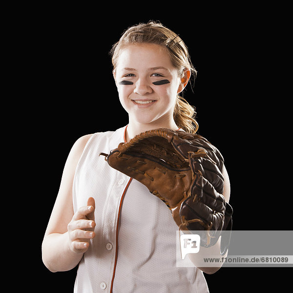 Portrait of girl (12-13) plying softball  studio shot