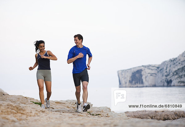 France  Marseille  Couple jogging by seaside