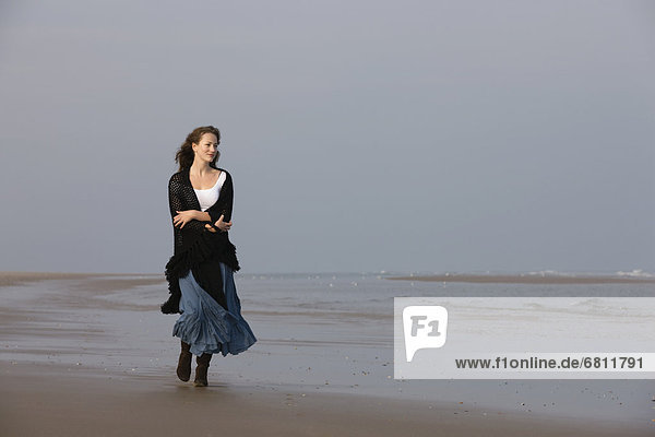 France  Pas-de-Calais  Escalles  Young woman strolling on empty beach