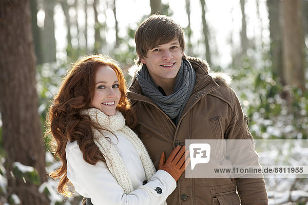 Young couple embracing in winter scenery