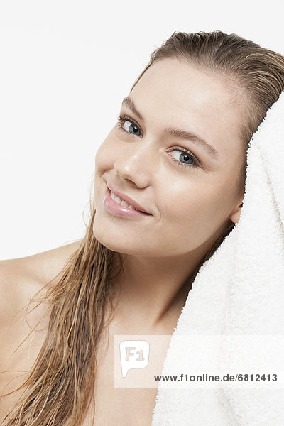 Portrait of young woman with wet hair and towel