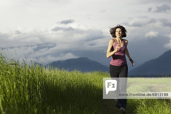 USA  Montana  Whitefish  Woman jogging on mountain path
