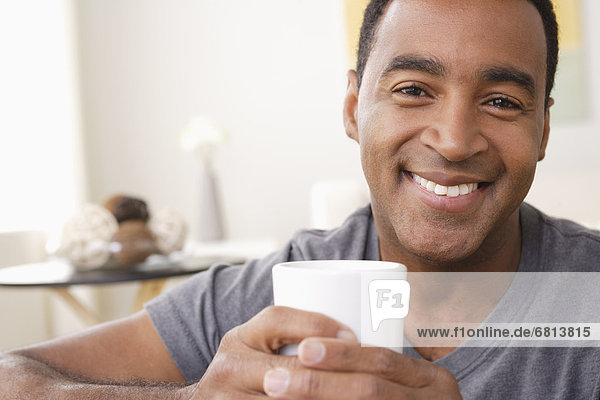 Portrait of smiling mature man holding mug