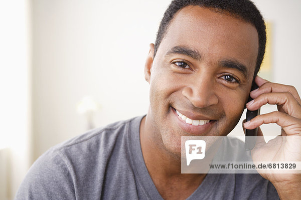 Portrait of smiling mature man talking via mobile