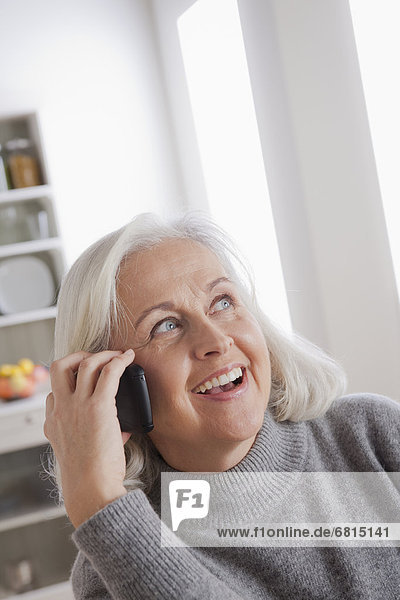 Portrait of smiling senior woman using mobile