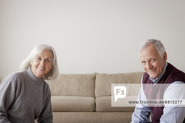 Portrait of senior couple sitting on sofa