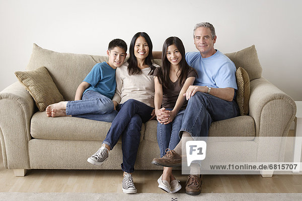 Cheerful family sitting on sofa