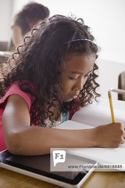 Portrait of schoolgirl (10-11) writing